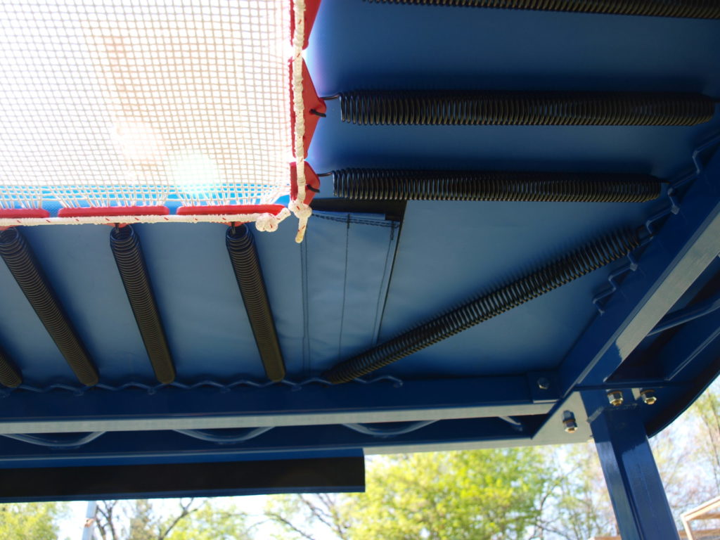 Detail of an above ground trampoline corner from below.