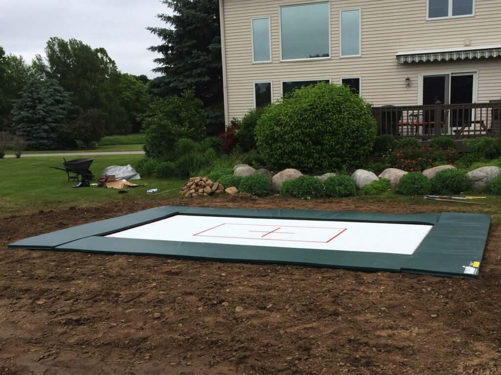 A flybed 6x12 foot in ground trampoline. Are in ground trampolines safer? By design, yes.