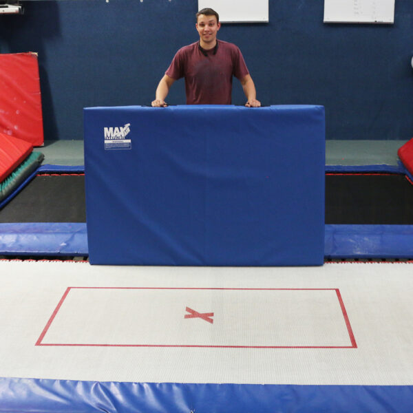 scale shot of a pitch mat with a person beside a trampoline