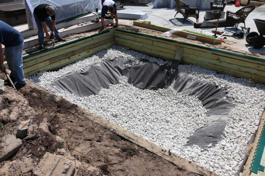 A pit set foundation for an in-ground trampoline. This provides ample space for bouncing and allows drainage.
