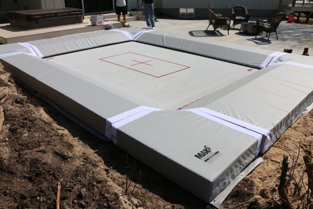A pit set foundation lies beneath this completely installed MaxAir Trampolines kit.