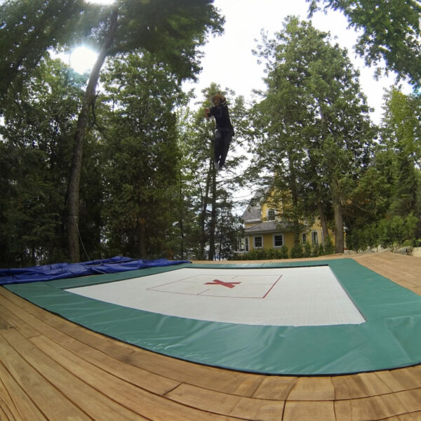 An in-ground trampoline in use.