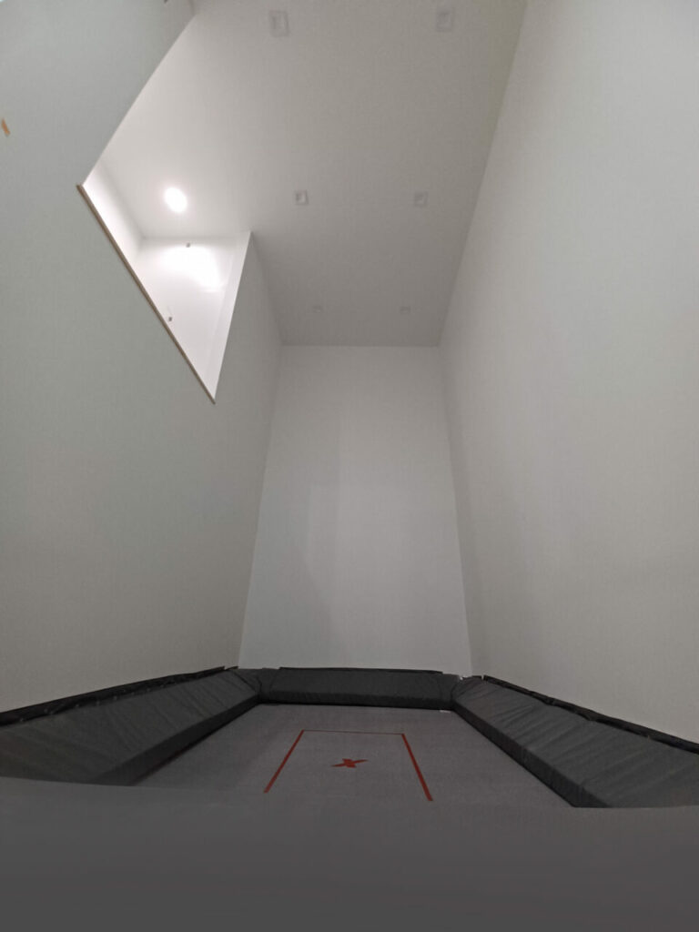 A trampoline room in shades of gray for a truly neutral, liminal experience.