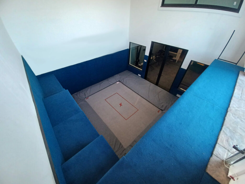 A custom trampoline room with carpet-bonded foam in blue.